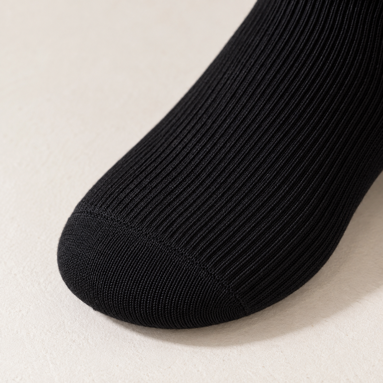 AI close product illustration of the rounded Black toe and adjoining fine vertical knit.