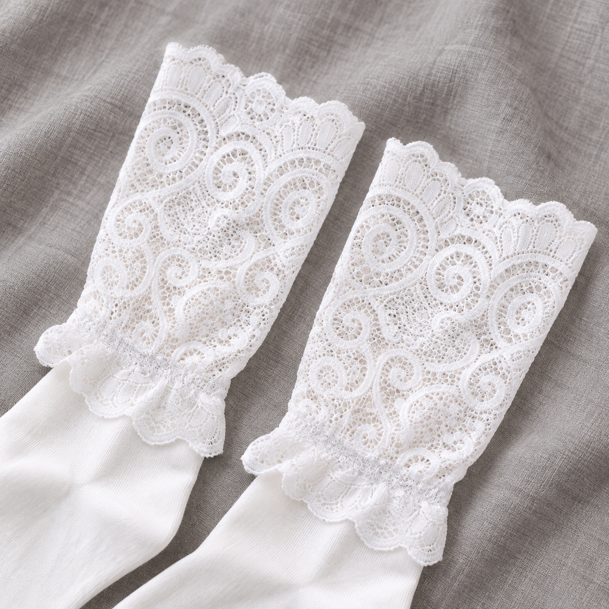 AI close product illustration of White scroll-pattern lace uppers with scalloped rims and a small transition ruffle.