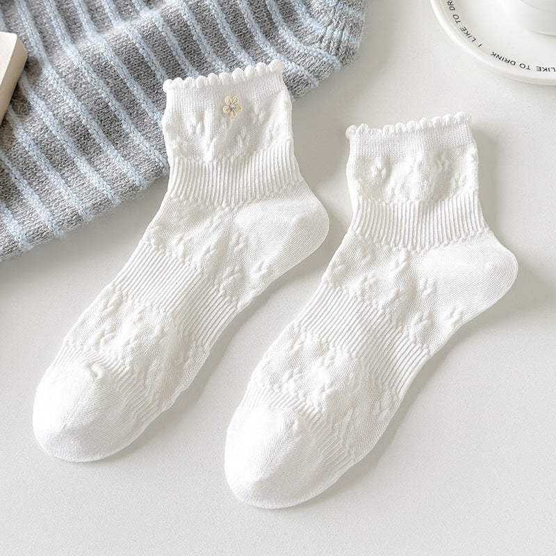 Untouched original reference of the White pair with raised diagonal texture bands, fine ribs, small scalloped openings and one visible outer daisy.