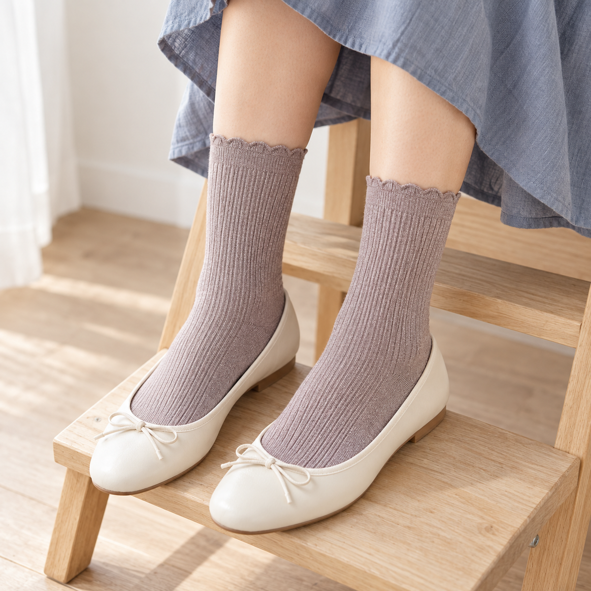 AI styling illustration of Heather Taupe fine-rib socks with cream flats, shown from above on pale wooden steps beneath a blue-gray skirt.