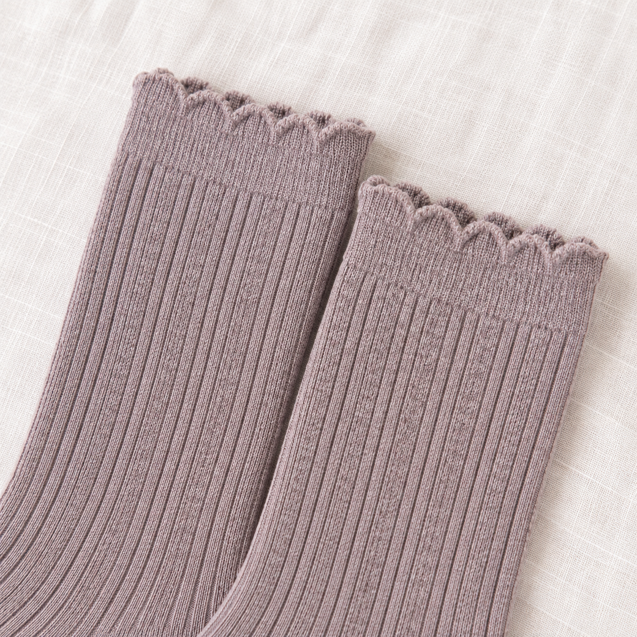 AI product detail of Heather Taupe sock openings with narrow wavy edges, a subtle upper band and fine vertical ribs on off-white linen.