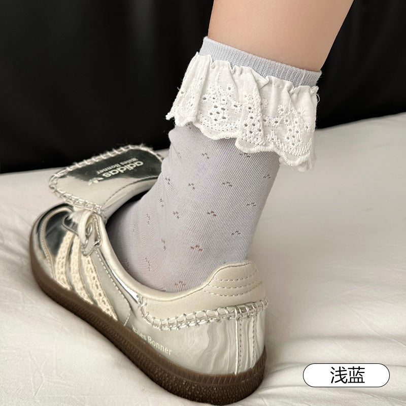 Untouched original Light Blue sock reference showing White embroidered scalloped flounce and small grouped eyelets; original color label and shoe-prop lettering remain unchanged.