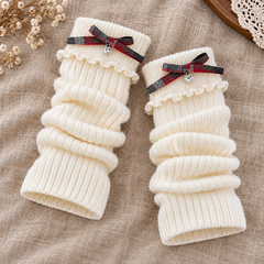 AI flat-lay illustration of White open-ended leg warmers, showing foldover plaid-bow cuffs and plain ribbed lower openings.