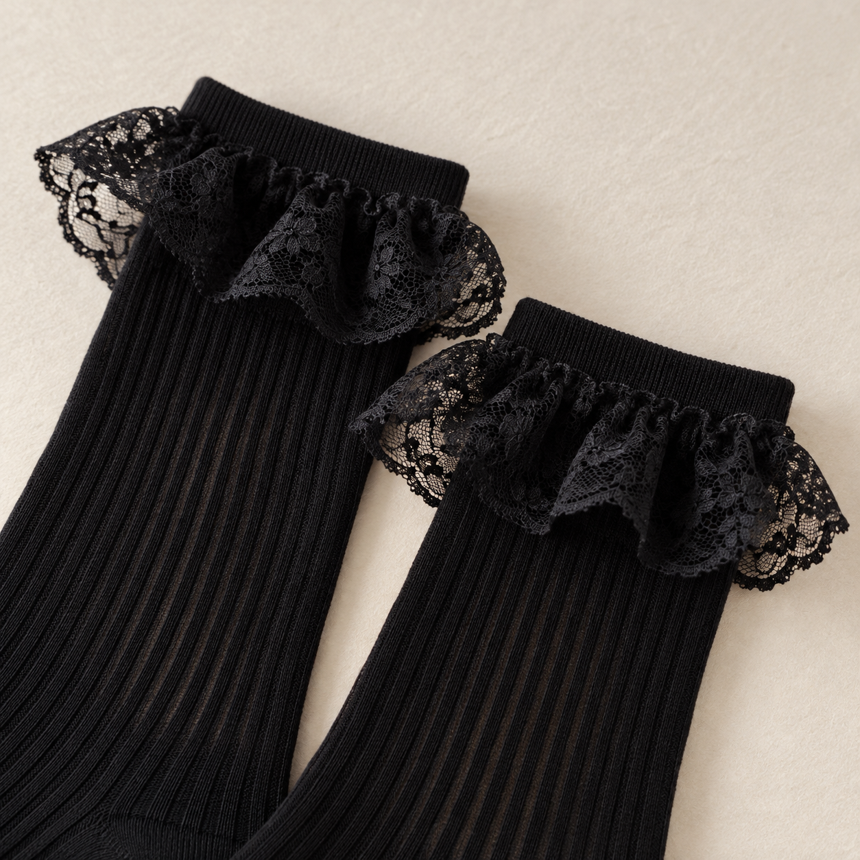 AI editorial illustration of Black ribbed sock cuffs with short plain knit lips above single gathered Black floral lace flounces.