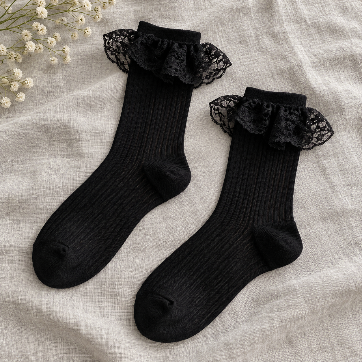 AI editorial illustration of Matching Black footed ribbed sock pair with rounded toes, shaped heels and single Black lace flounces on gray linen.