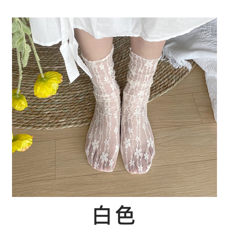 Untouched original reference of a White fully sheer flower-chain sock pair, transparent foot, narrow edging and external White photo label.