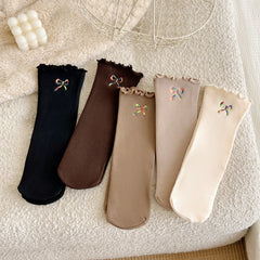Five-color ribbed sock flatlay; offered Black is far left and Dark Coffee second from left; other colors are reference only, one selected pair
