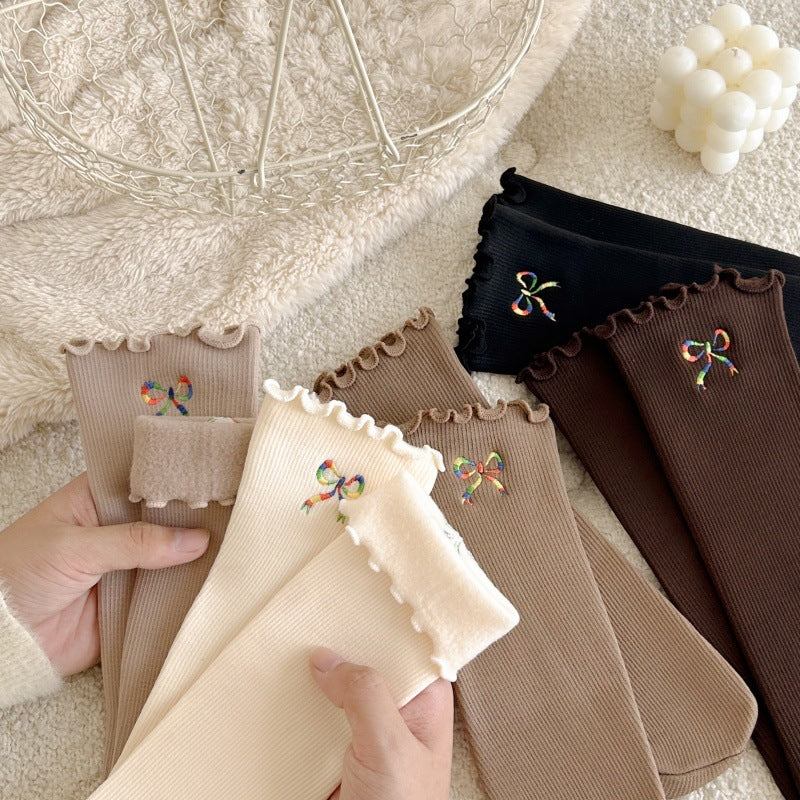 Hand-held display of bow-embroidered ribbed socks; offered Black is upper right and Dark Coffee below it; other colors are reference only