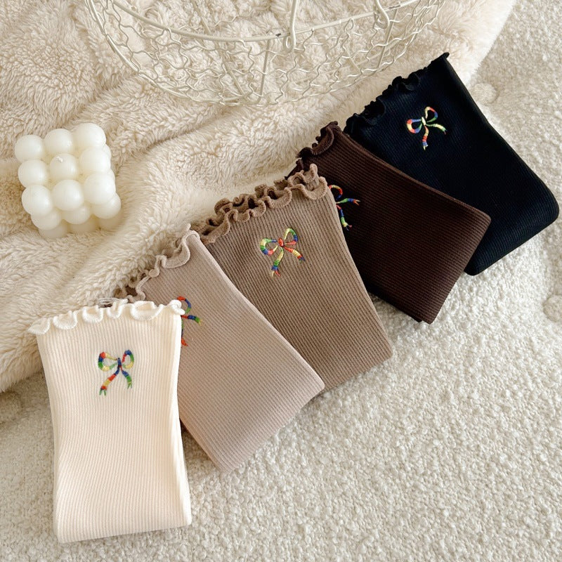 Folded bow-embroidered socks in a diagonal row; offered Black is far right and Dark Coffee second from right; other colors are reference only