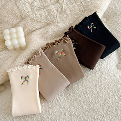 Folded bow-embroidered socks in a diagonal row; offered Black is far right and Dark Coffee second from right; other colors are reference only
