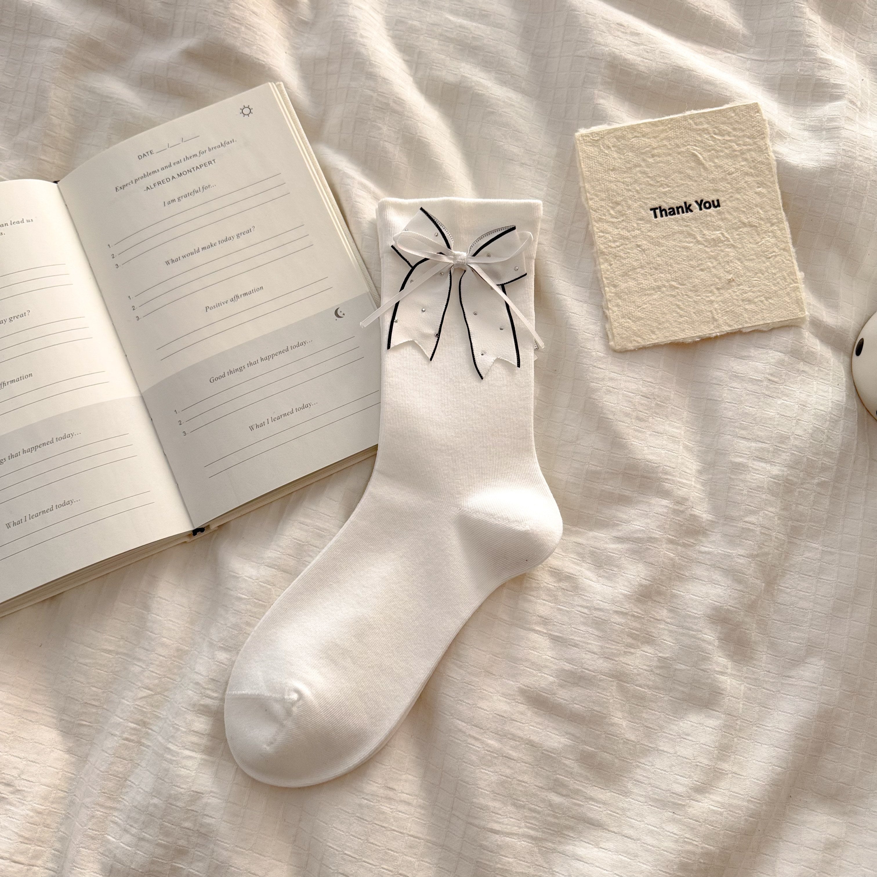 White crew socks with dark-edged bows and small decorative dot accents