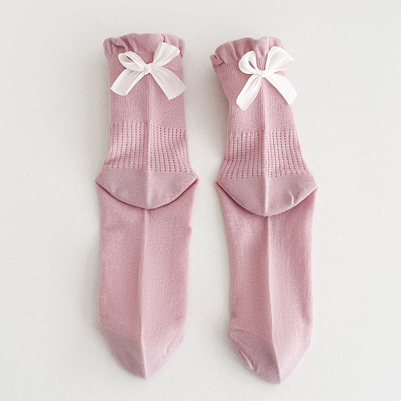 Untouched supplier reference of one Pink pair with broad white ribbon bows, upper grids, vertical eyelet bands and plain feet