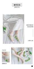 Green Plaid sheer ankle socks worn with a white skirt, with other sock styles used as photo props