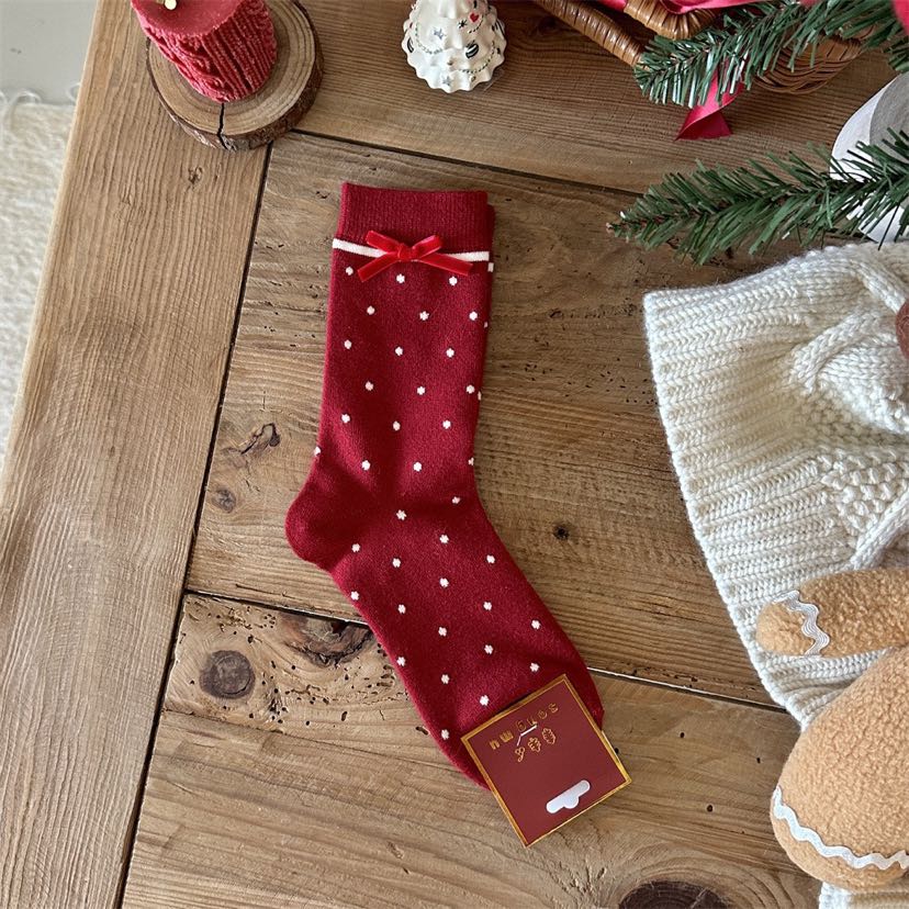 Red crew sock with white polka dots, a red bow and a white stripe below the cuff