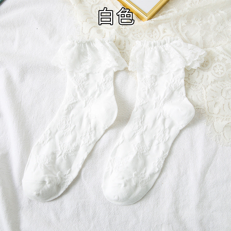 Original supplier reference of one White pair with raised flower-and-leaf vines and broad scalloped lace flounces