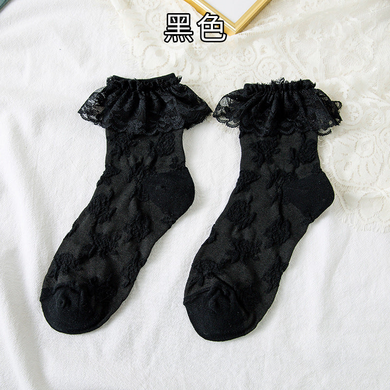 Original supplier reference of one Black pair with raised floral vines and broad outward lace flounces