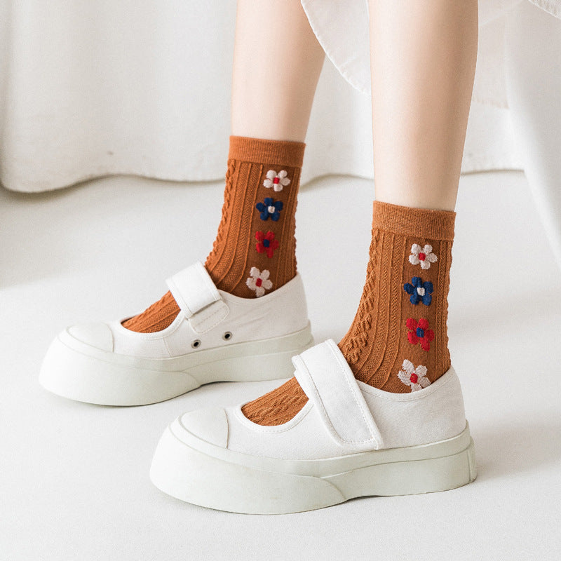 Brown raised-flower knit socks shown worn, one selected pair