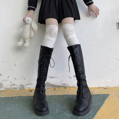 White ribbed long socks with floral lace cuffs styled above tall black boots