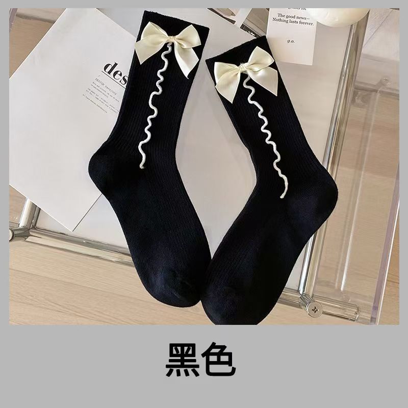 Black ribbed crew socks with cream ribbon bows and white wavy cord details