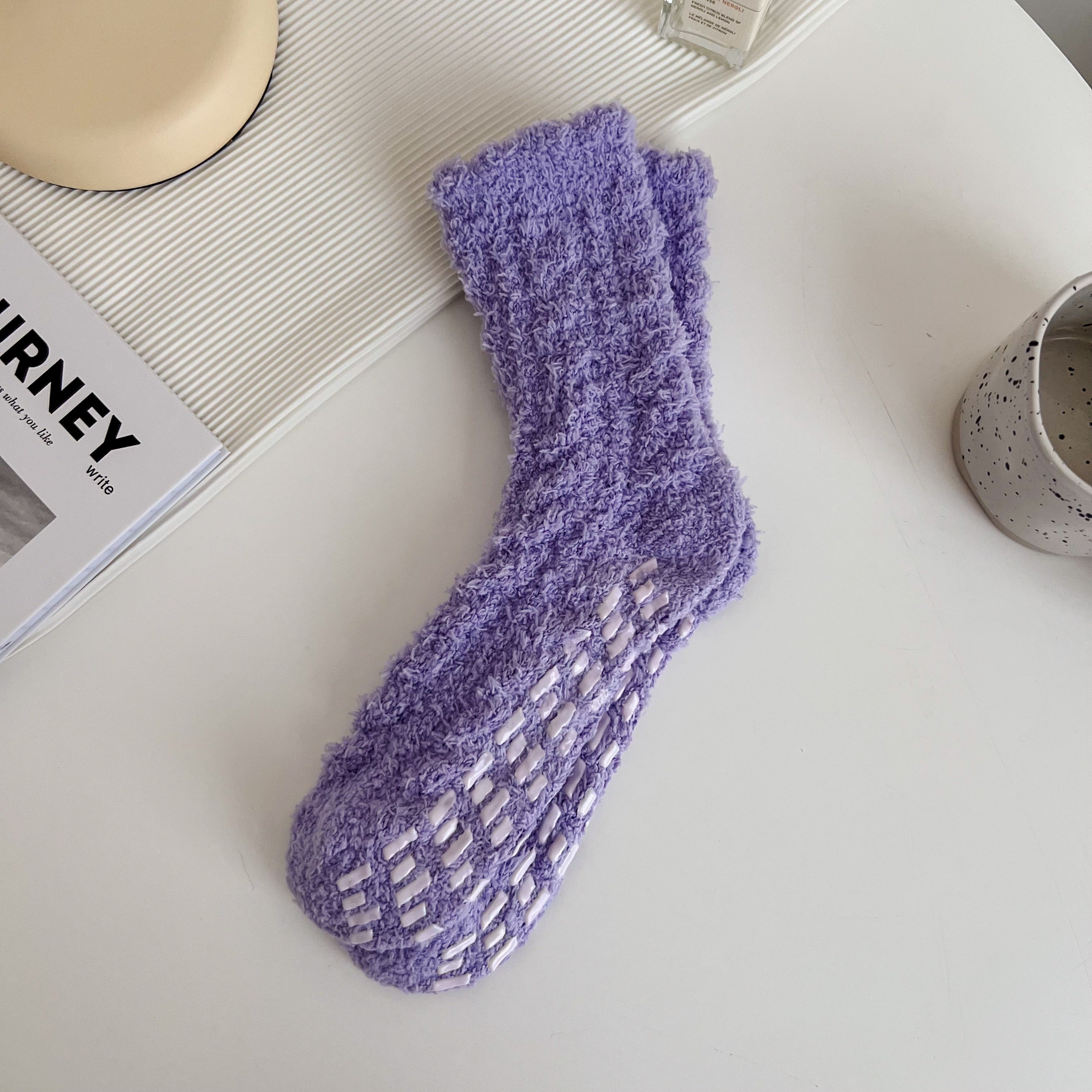 Purple textured crew socks with scalloped cuffs and visible white sole bars