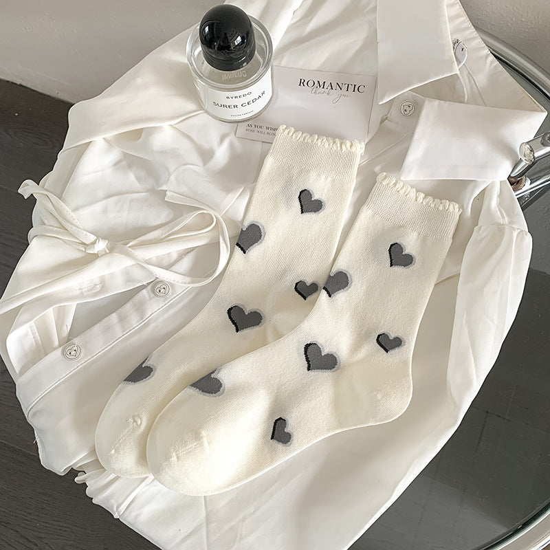 White Hearts socks with gray heart motifs and a frilled cuff edge