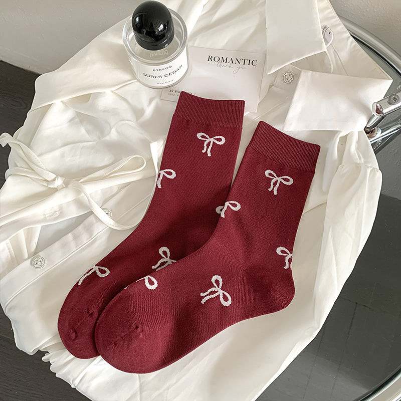 Burgundy Bows socks with pale bow motifs and straight cuffs