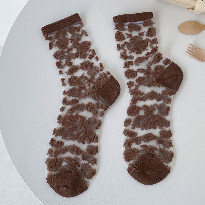 Pair of Coffee sheer crew socks with textured brown floral motifs and denser cuffs, toes and heels