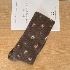 Coffee calf sock with scattered tiny flower clusters and fine rib texture