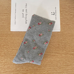 Gray calf sock with tiny flower clusters across a fine ribbed body