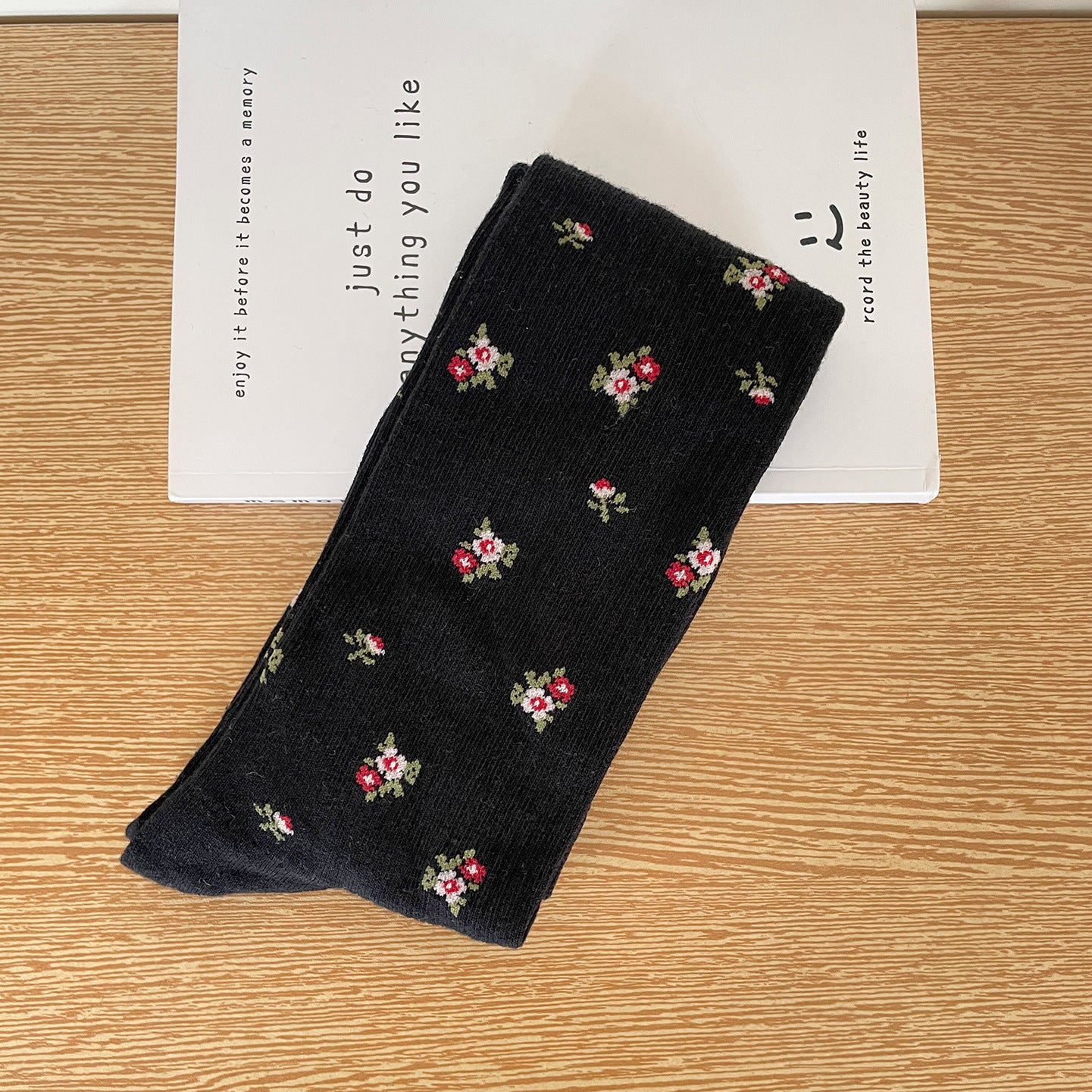 Black calf sock with scattered tiny flower clusters and fine rib texture