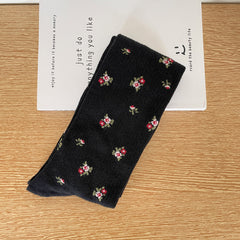 Black calf sock with scattered tiny flower clusters and fine rib texture