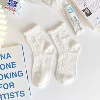 Untouched supplier reference of one White pair with tonal elongated diamond patterns and narrow frilled cuffs