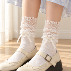 AI-assisted close styling view of Milky White scrolling lace sleeve cuffs, gathered lower edges and low ribbon bows